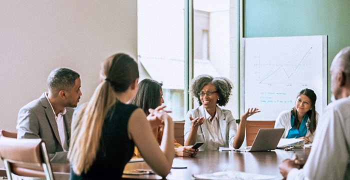 A business meeting being held around a table